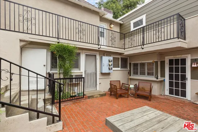 a view of a patio with table and chairs