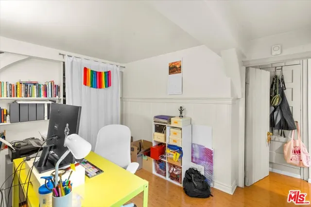 a bedroom with furniture and a book shelf
