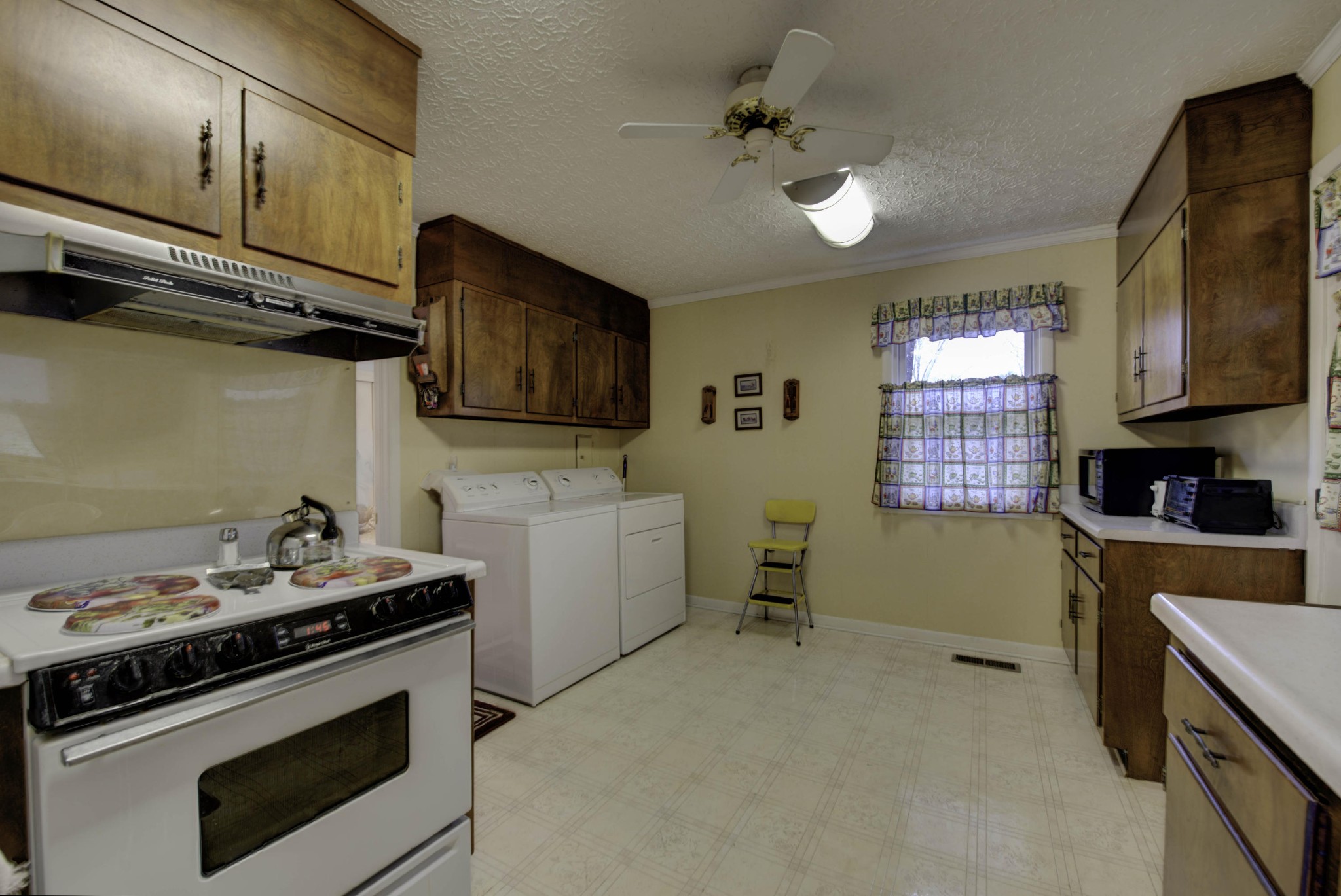112 South Seneca Road Oak Ridge, TN 37830 - Photo 6 of 20 a kitchen with a stove and a microwave