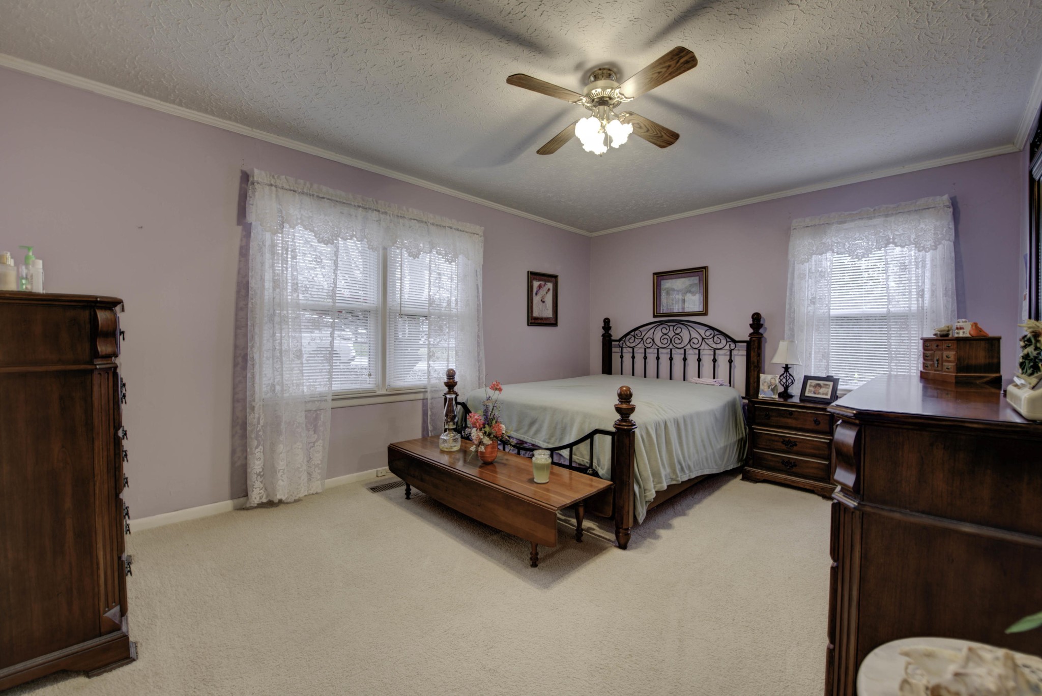 112 South Seneca Road Oak Ridge, TN 37830 - Photo 10 of 20 a spacious bedroom with a bed and a chandelier