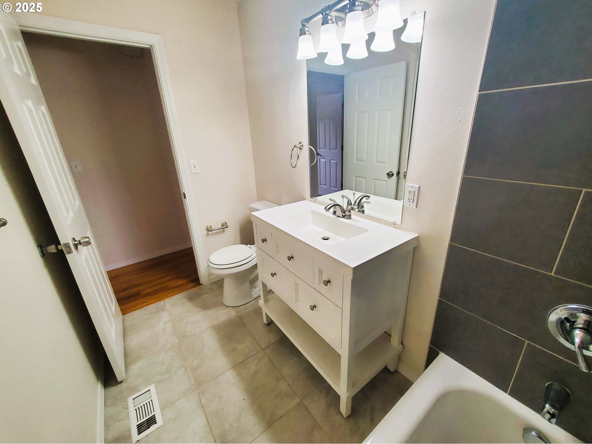 13050 Southeast Morrison Street Portland, OR 97233 - Photo 12 of 21 a bathroom with a sink a toilet a mirror and vanity
