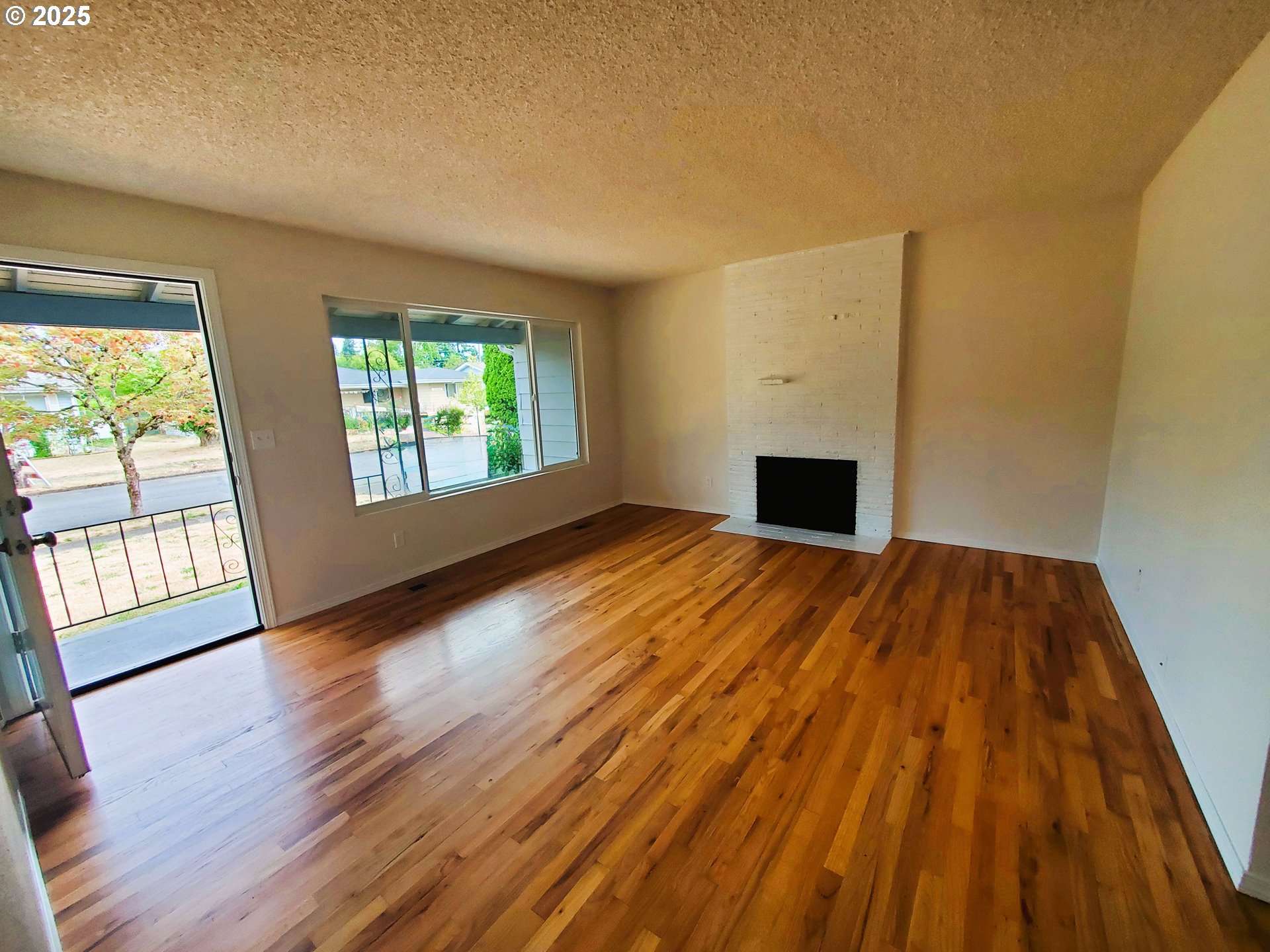13050 Southeast Morrison Street Portland, OR 97233 - Photo 3 of 21 a view of an empty room with wooden floor and a window
