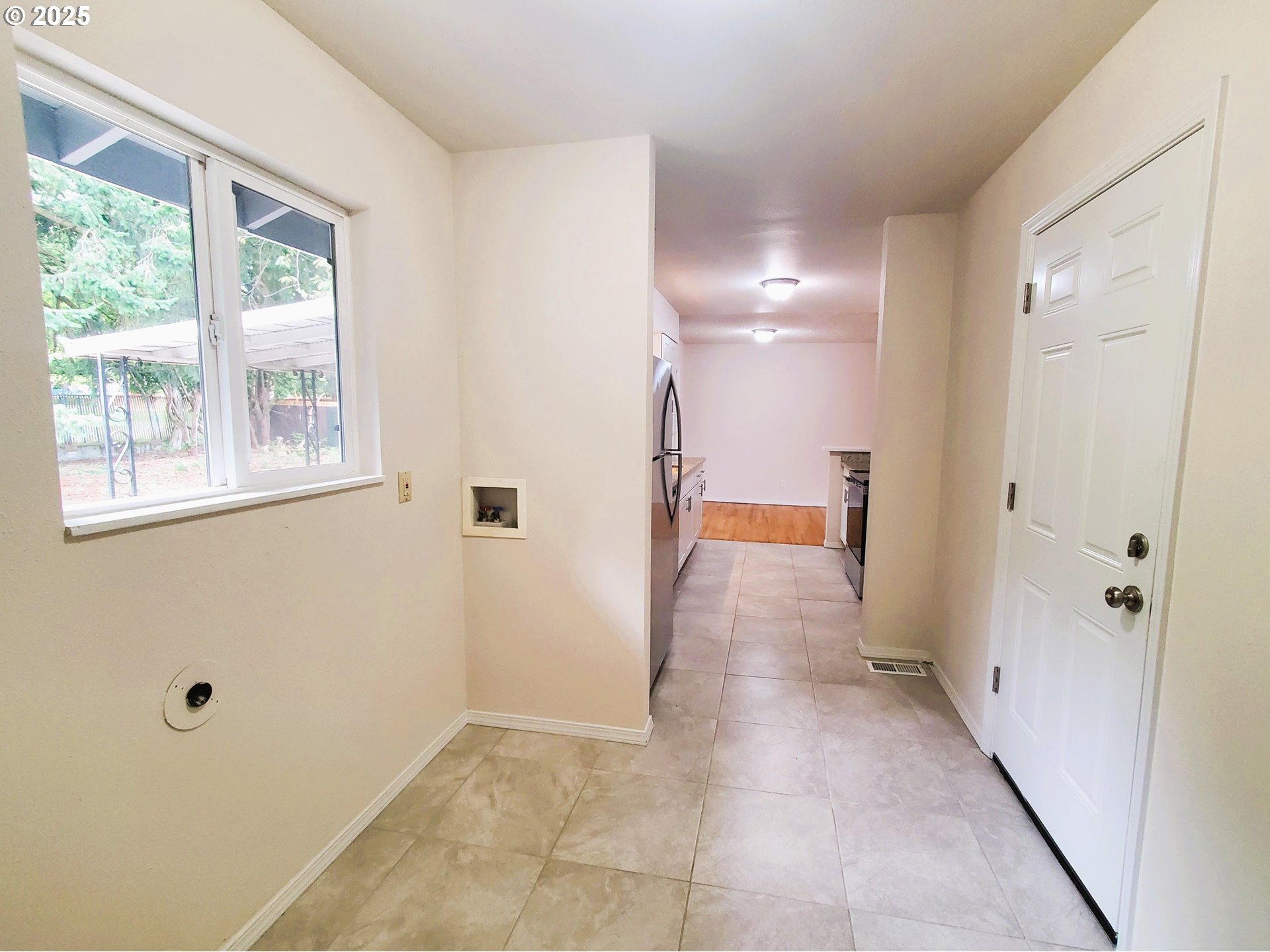 13050 Southeast Morrison Street Portland, OR 97233 - Photo 7 of 21 a view of a hallway with wooden floor and a bathroom