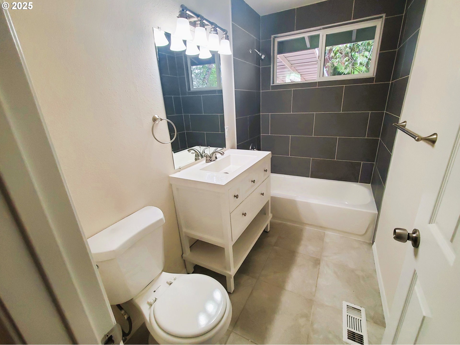 13050 Southeast Morrison Street Portland, OR 97233 - Photo 10 of 21 a bathroom with a sink a toilet a mirror and shower