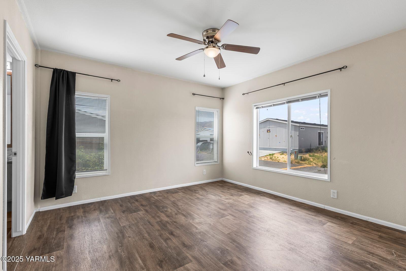 2802 South 5th Avenue, Unit 30 Union Gap, WA 98903 - Photo 17 of 23 a view of an empty room with a window and wooden floor