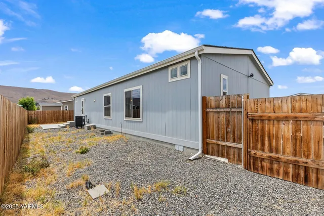 a view of a house with wooden fence
