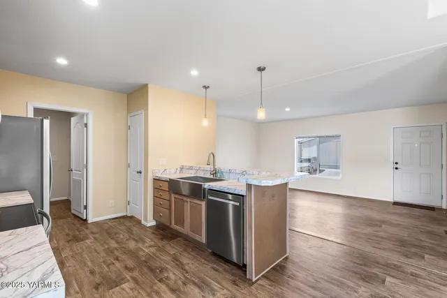 a kitchen with stainless steel appliances granite countertop a stove and a refrigerator