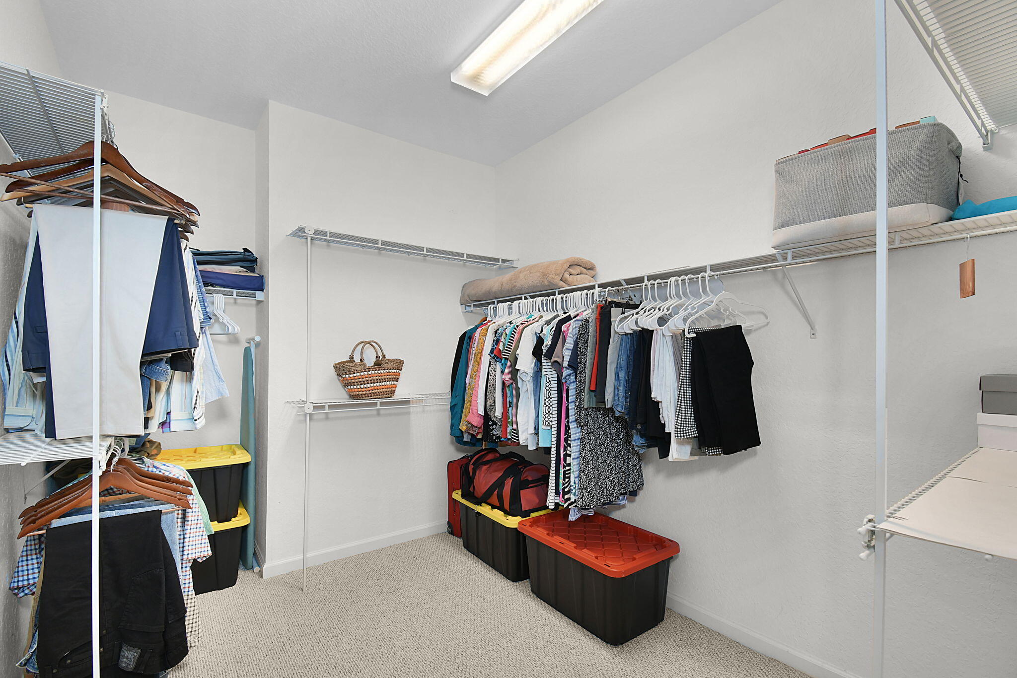 254 Southwest Walking Path Stuart, FL 34997 - Photo 24 of 31 a view of walk in closet with clothes and shoes