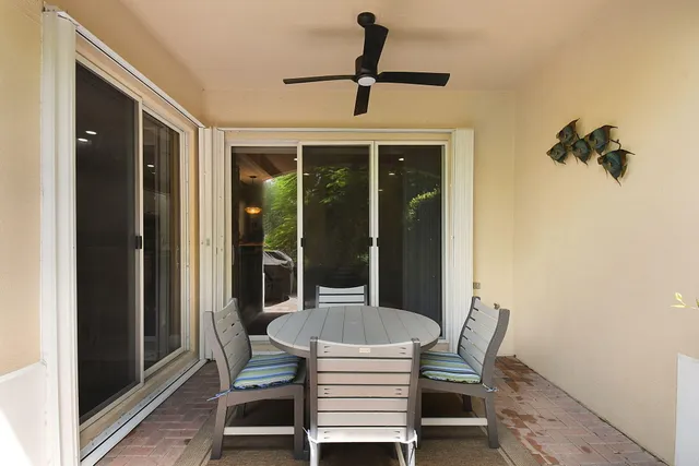 a view of a backyard with table and chairs potted plants and a backyard
