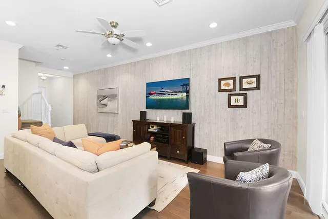 a living room with stainless steel appliances kitchen island furniture and a large window