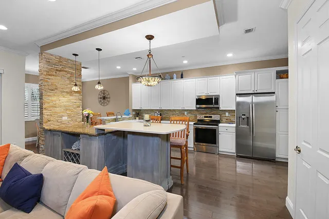 a large kitchen with a table and chairs