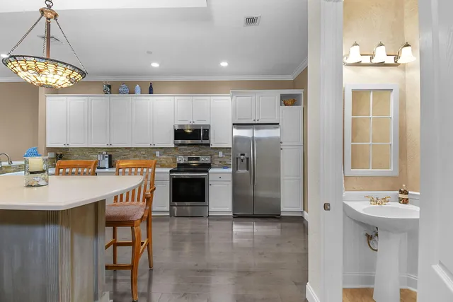 a kitchen with stainless steel appliances kitchen island granite countertop a sink and cabinets