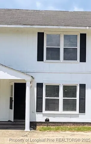 a front view of a house with a lots of windows