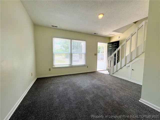 a kitchen with stainless steel appliances granite countertop a refrigerator a stove a sink and a refrigerator