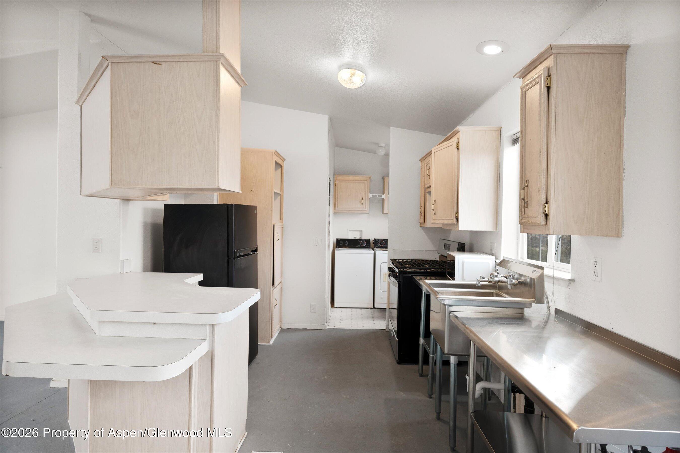 378 Alta Mesa Road Silt, CO 81652 - Photo 12 of 20 a kitchen with a sink a stove and a refrigerator