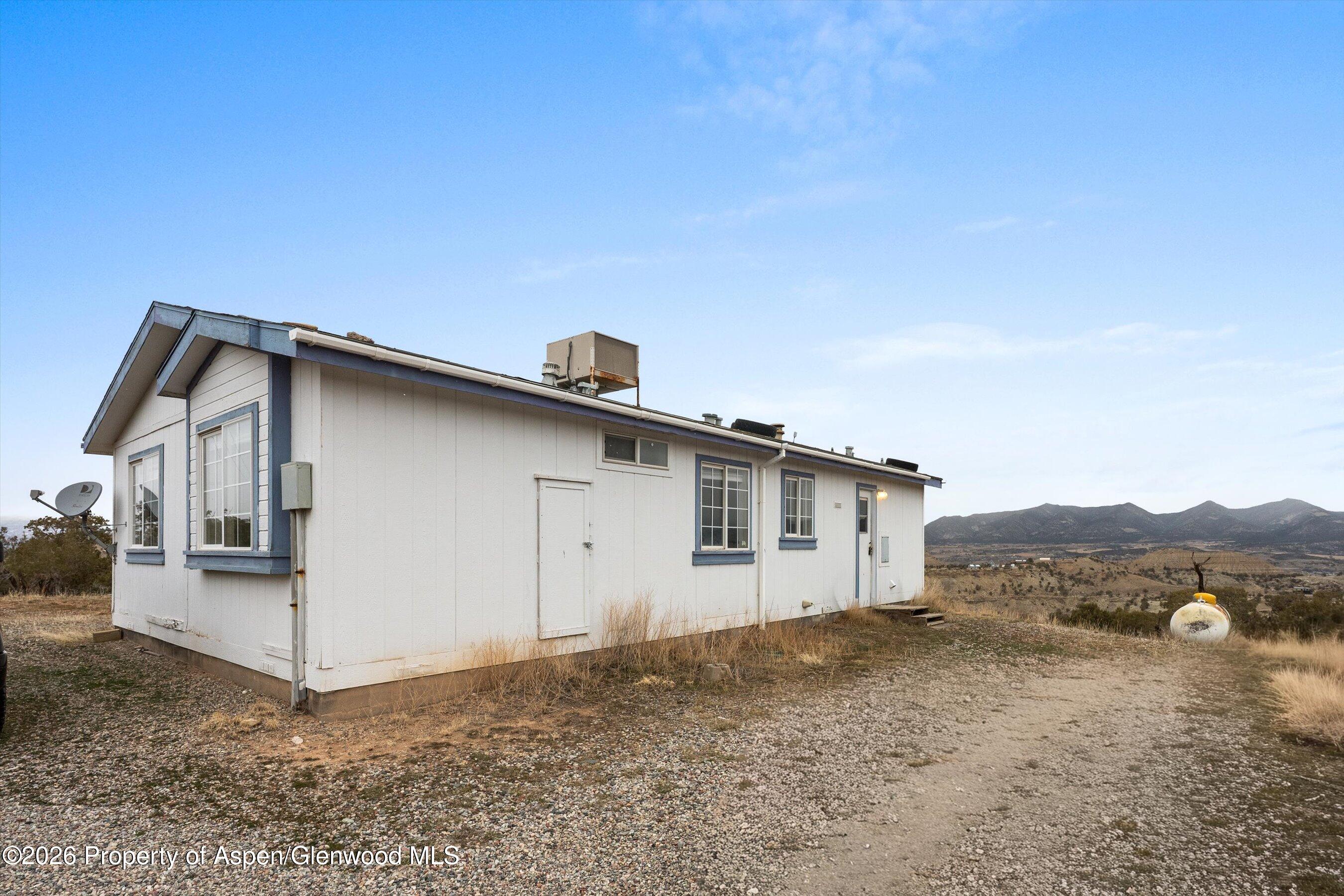 378 Alta Mesa Road Silt, CO 81652 - Photo 6 of 20 a view of a house with a backyard