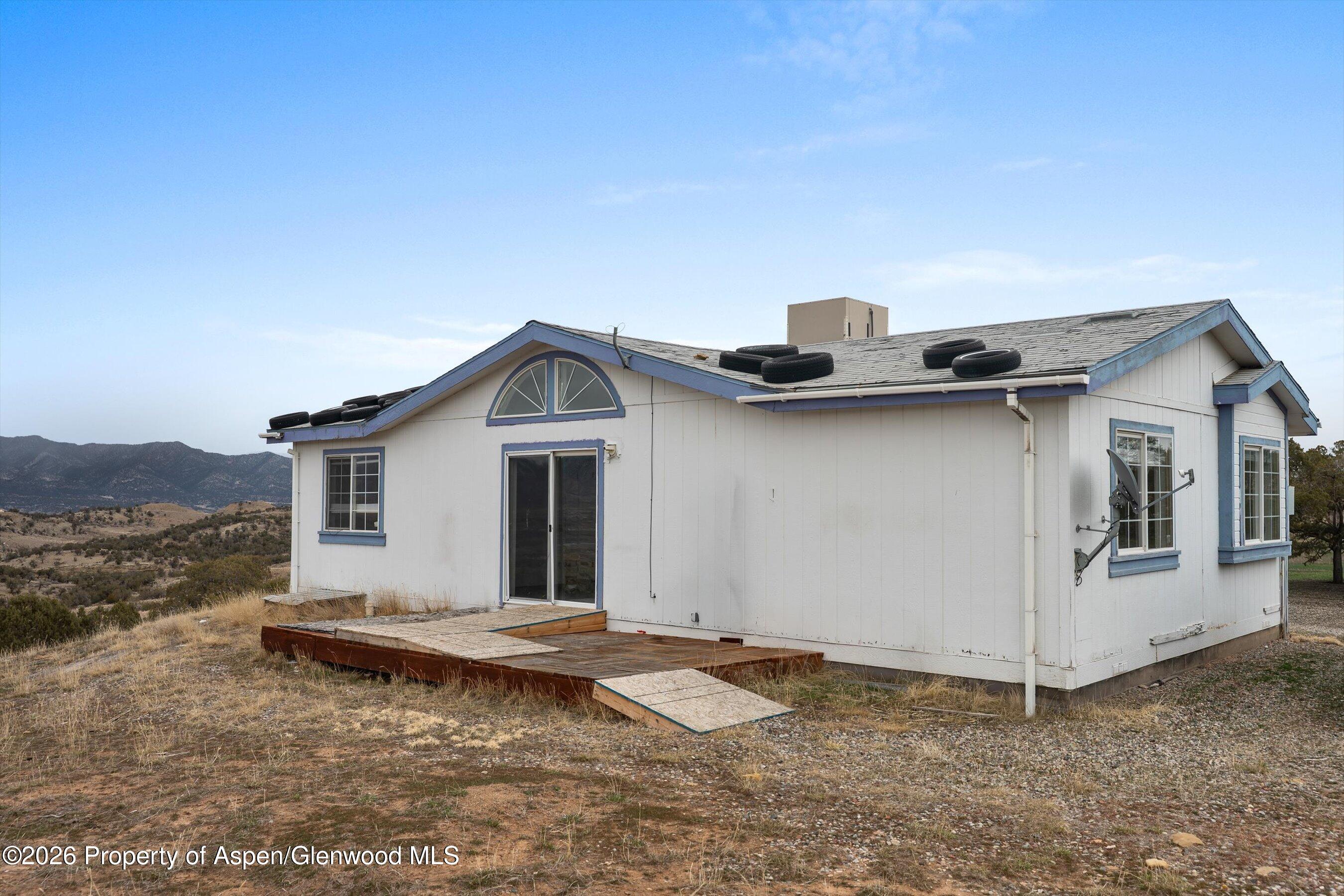 378 Alta Mesa Road Silt, CO 81652 - Photo 7 of 20 a view of a house with a backyard