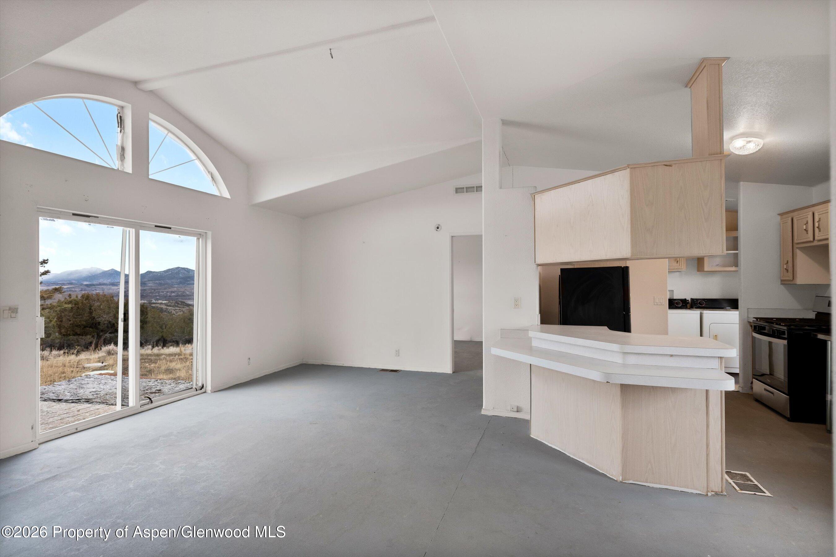 378 Alta Mesa Road Silt, CO 81652 - Photo 8 of 20 a view of open kitchen with cabinets and outdoor space