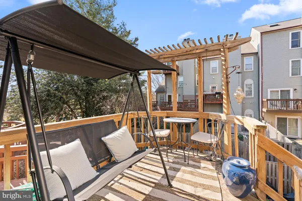 a view of a patio with table and chairs and wooden floor