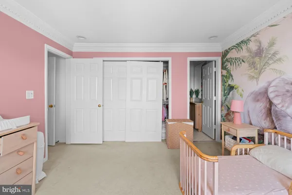 a bedroom with a bed and potted plant on the table