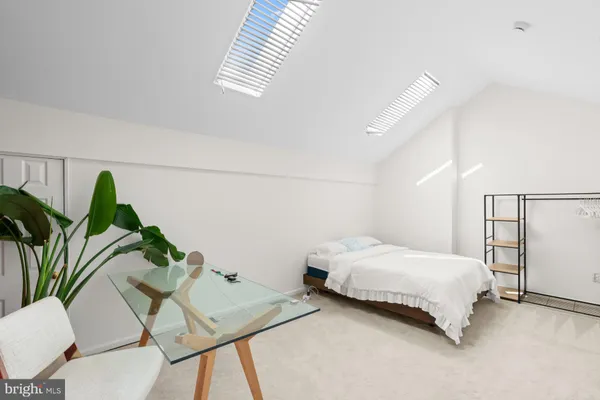 a bedroom with a bed and a table