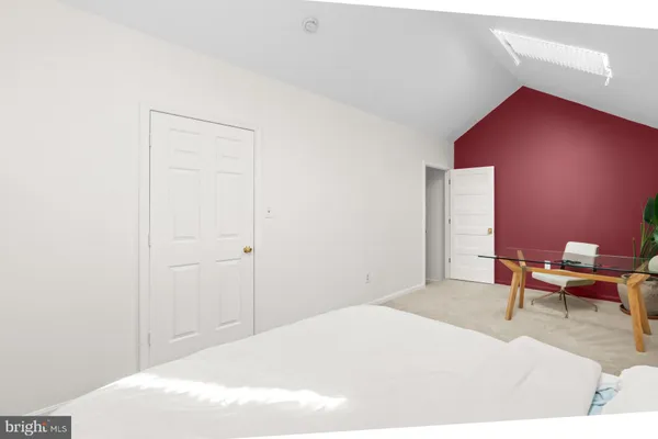 a bedroom with a bed and a workspace