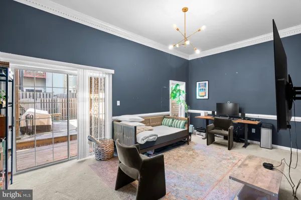 a livingroom with workspace and a window