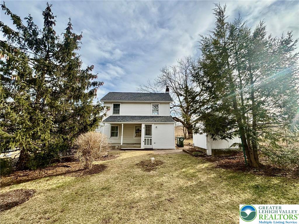 6024 Front Street Bangor, PA 18013 - Photo 3 of 12 a white house that has a tree in front of it