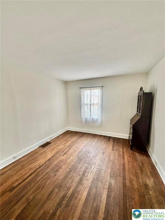 6024 Front Street Bangor, PA 18013 - Photo 8 of 12 a view of an empty room with wooden floor and a window