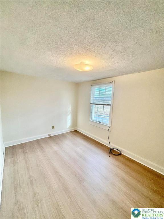 6024 Front Street Bangor, PA 18013 - Photo 9 of 12 an empty room with wooden floor and windows