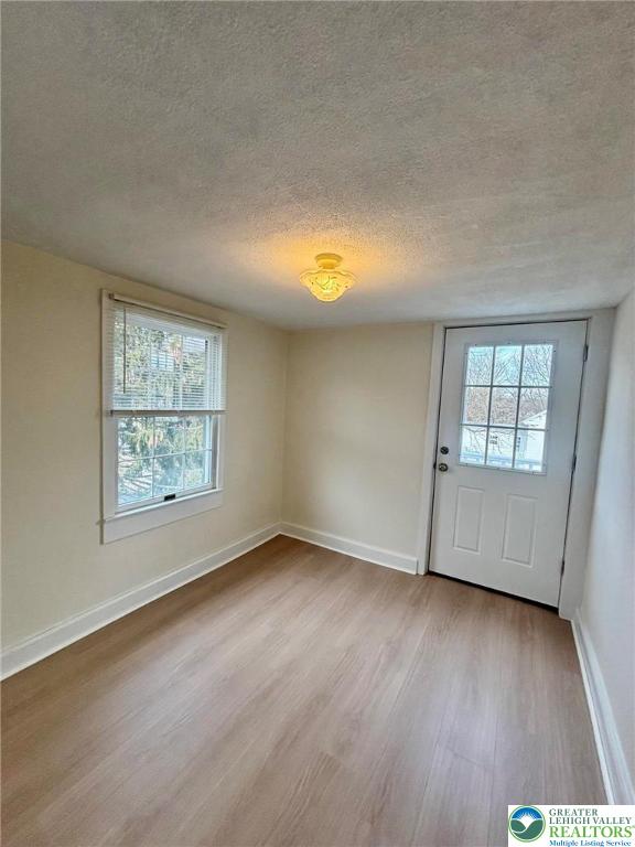 6024 Front Street Bangor, PA 18013 - Photo 10 of 12 an empty room with wooden floor and windows