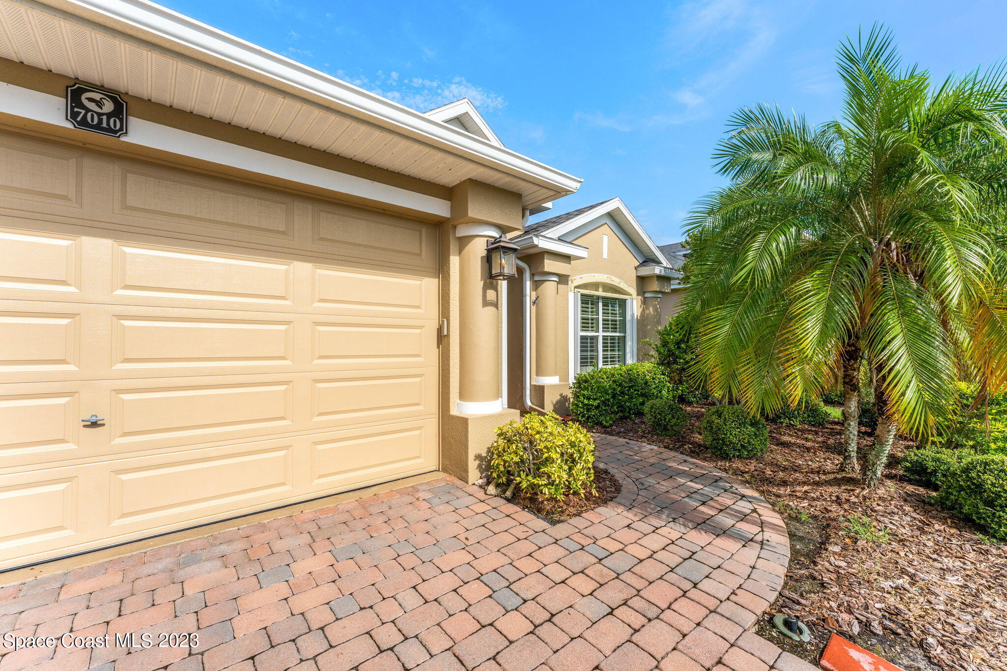 7010 Abbeyville Road Melbourne, FL 32940 - Photo 4 of 40 a front view of a house with a yard