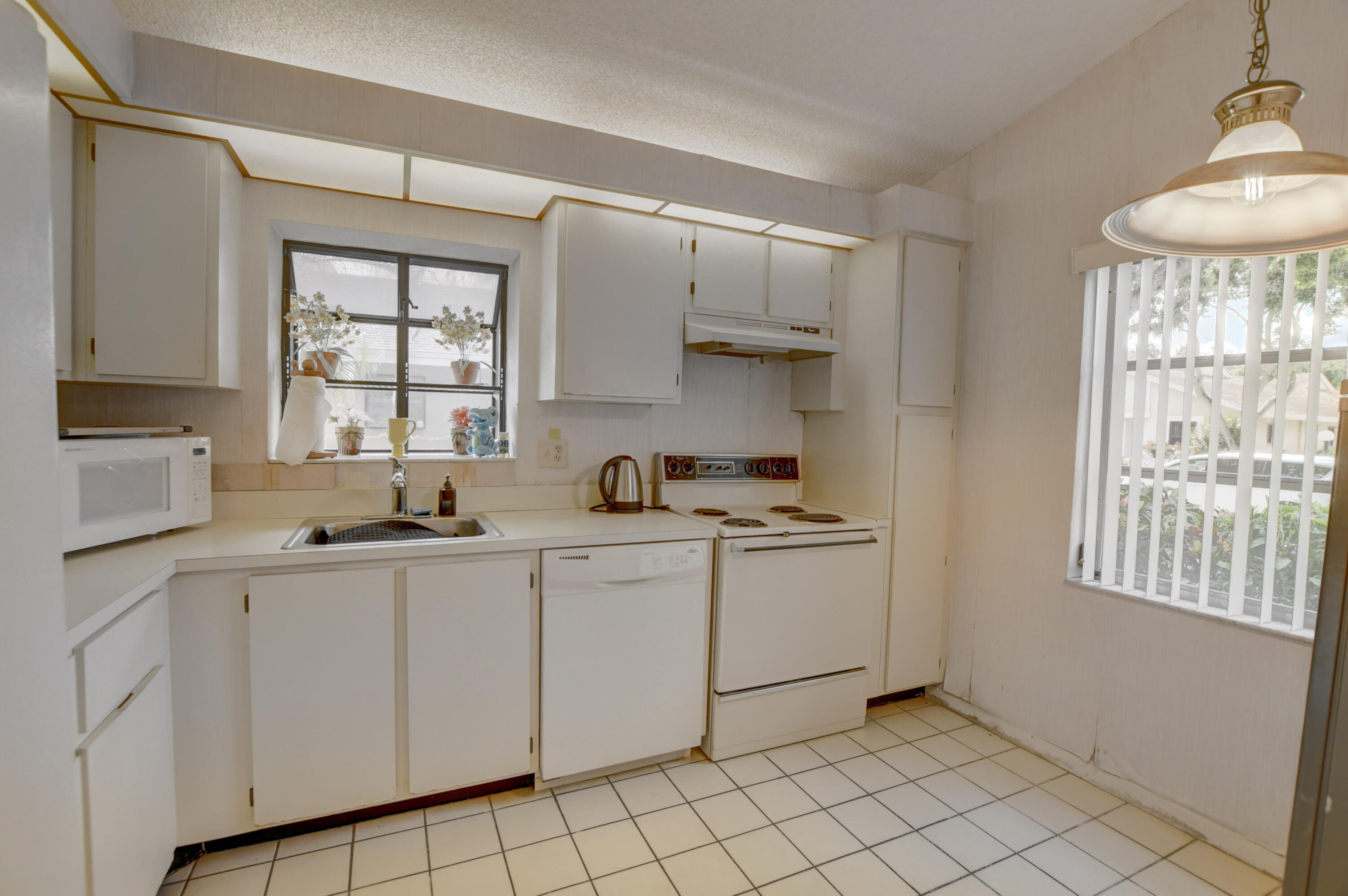 8089 Springtree Road Boca Raton, FL 33496 - Photo 11 of 44 a kitchen with stainless steel appliances granite countertop a sink and a stove