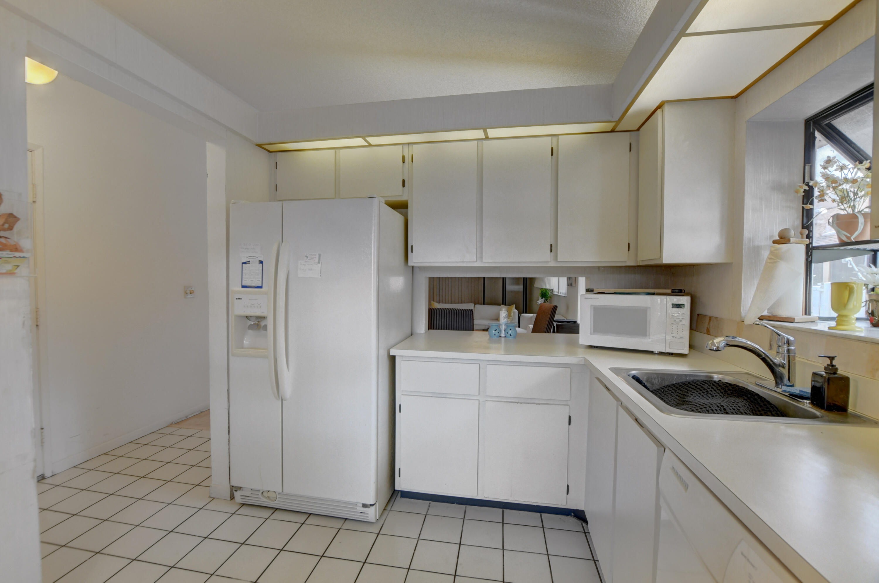 8089 Springtree Road Boca Raton, FL 33496 - Photo 12 of 44 a kitchen with a sink cabinets and appliances
