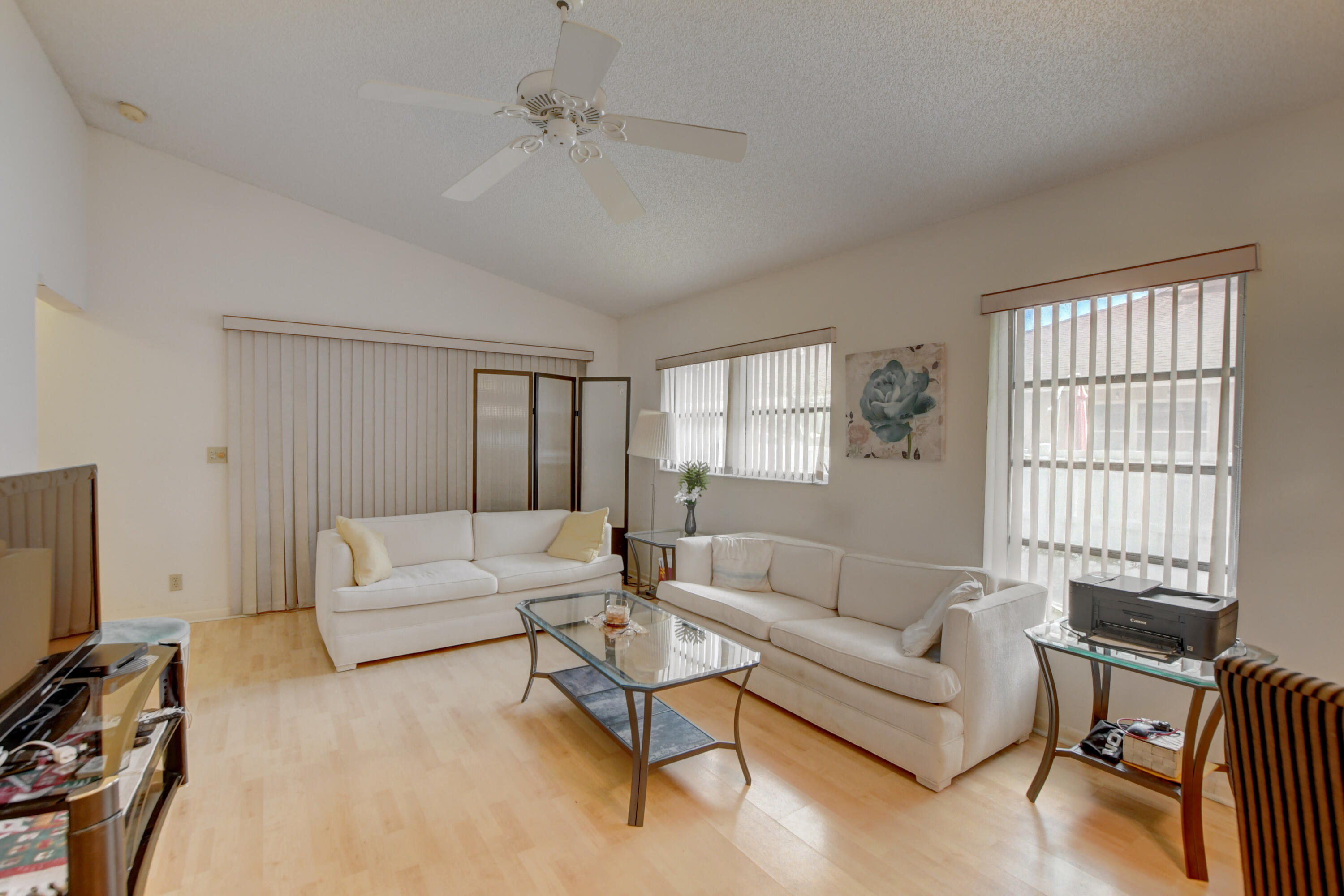 8089 Springtree Road Boca Raton, FL 33496 - Photo 16 of 44 a living room with furniture and a flat screen tv