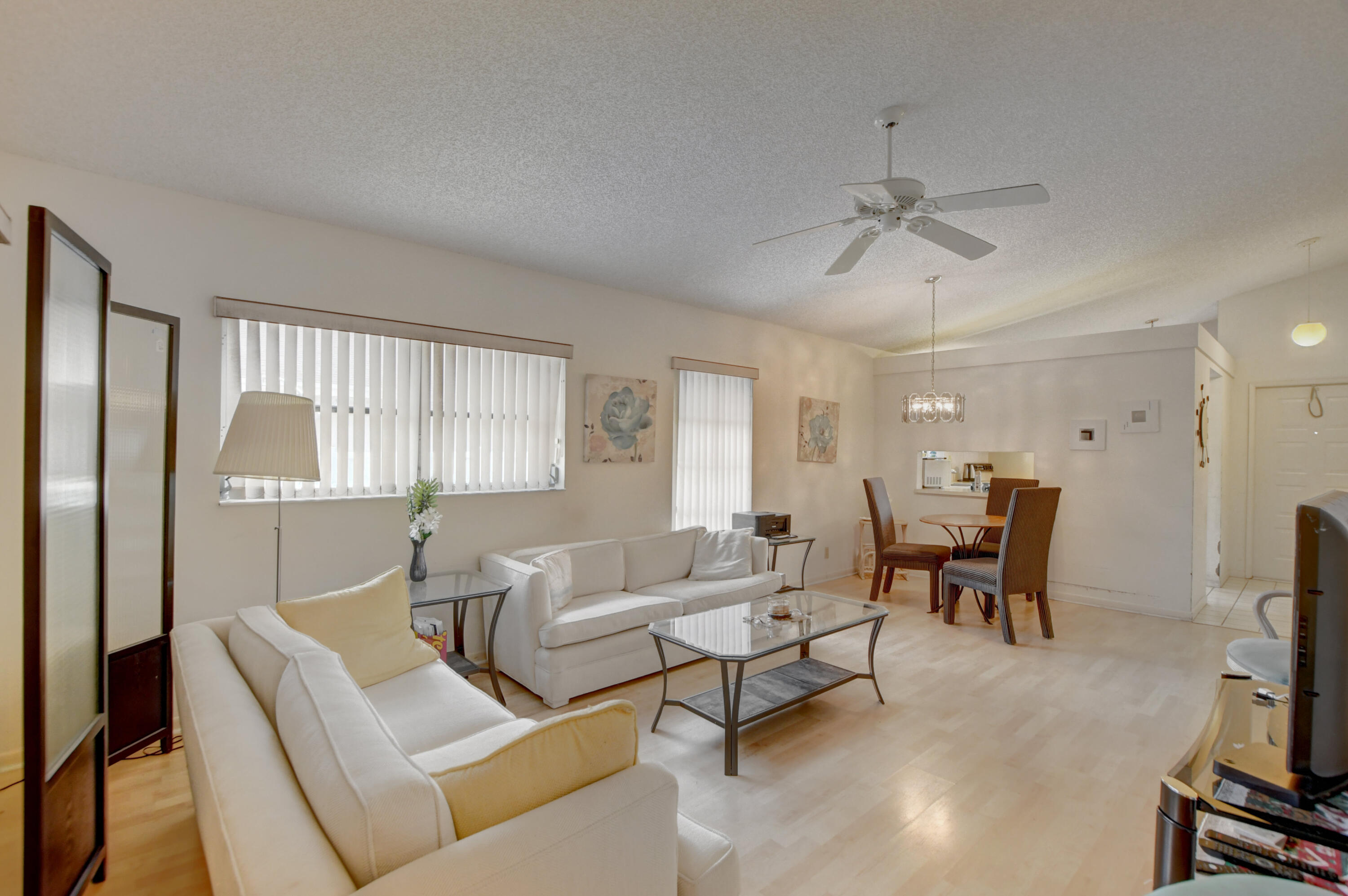 8089 Springtree Road Boca Raton, FL 33496 - Photo 18 of 44 a living room with furniture a ceiling fan and a window