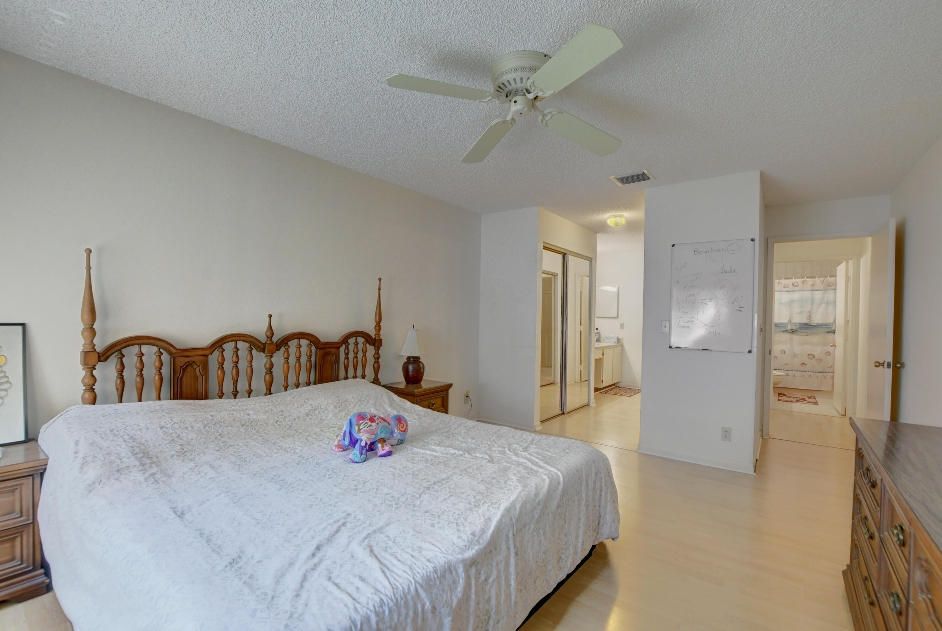 8089 Springtree Road Boca Raton, FL 33496 - Photo 20 of 44 a spacious bedroom with a bed and a table