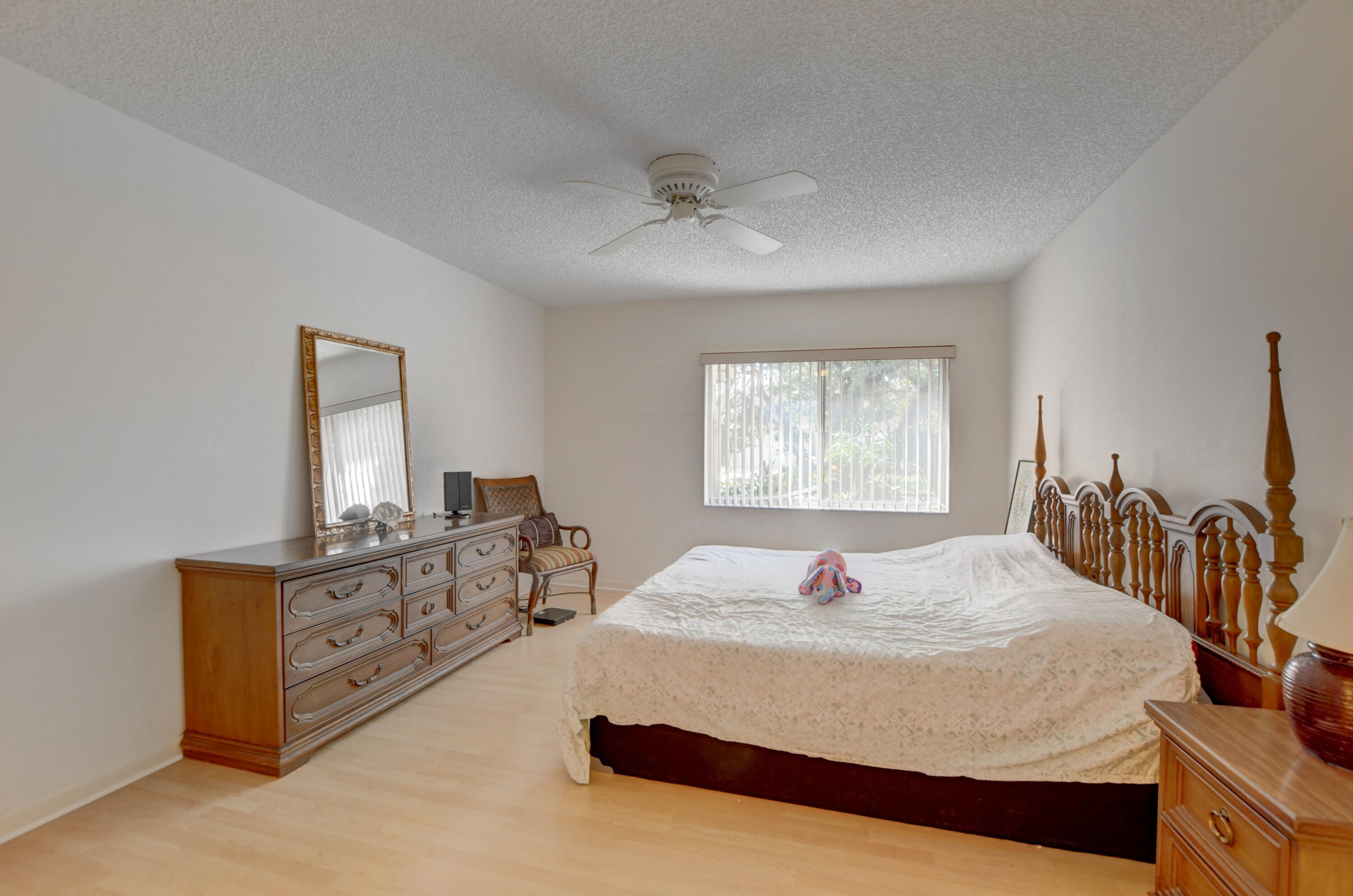 8089 Springtree Road Boca Raton, FL 33496 - Photo 21 of 44 a bedroom with a bed and dresser with mirror