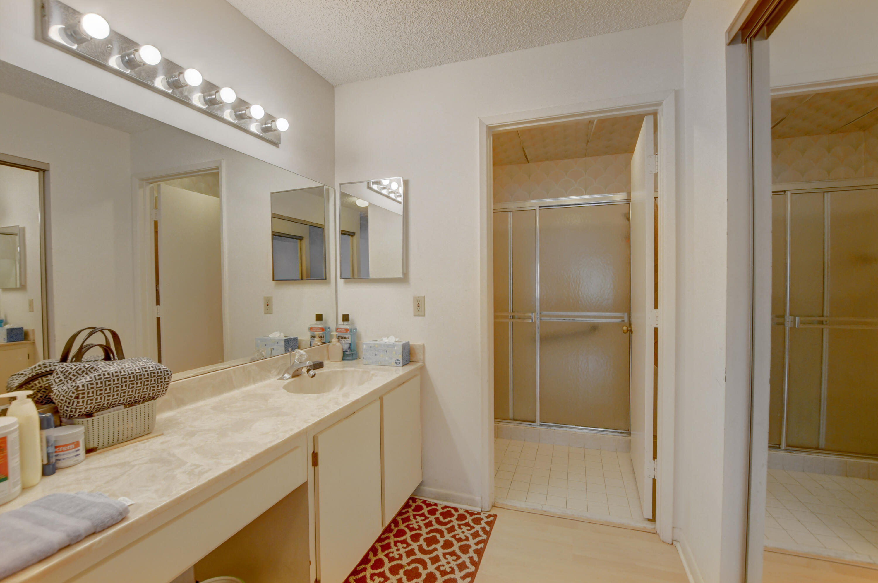 8089 Springtree Road Boca Raton, FL 33496 - Photo 22 of 44 a bathroom with a double vanity sink and a mirror