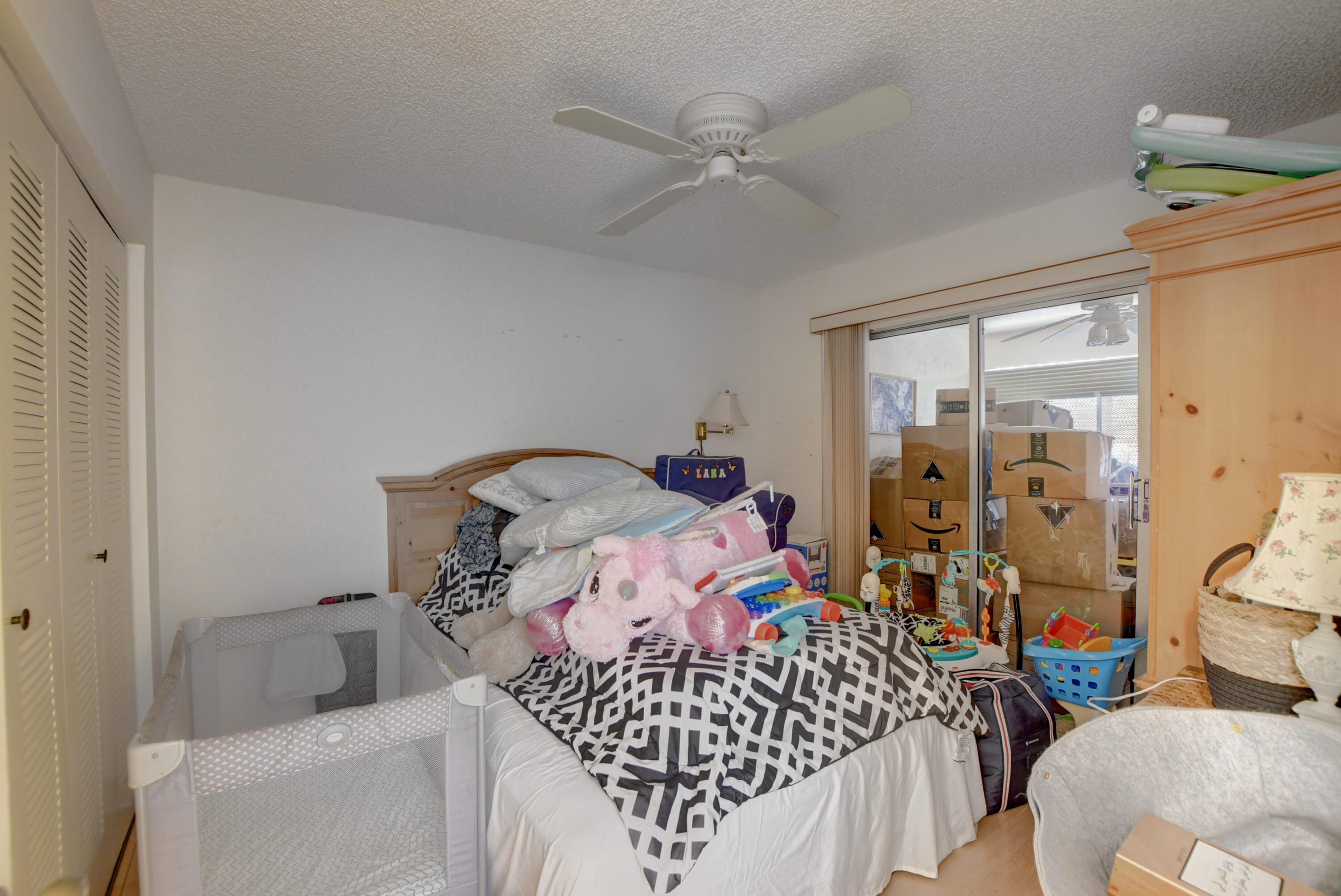 8089 Springtree Road Boca Raton, FL 33496 - Photo 28 of 44 a bedroom with bed and a window