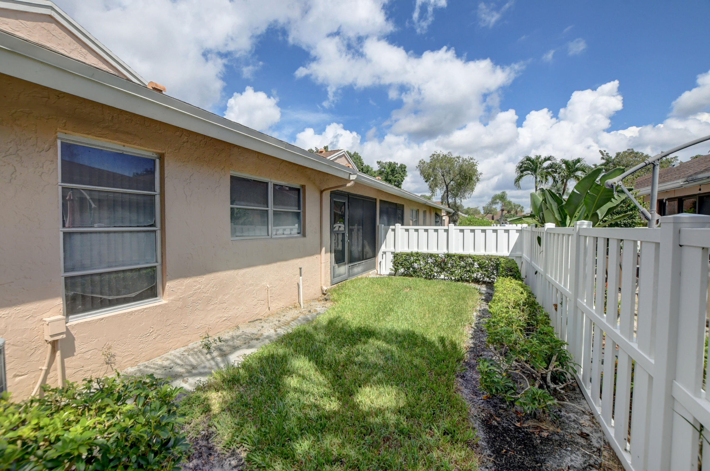 8089 Springtree Road Boca Raton, FL 33496 - Photo 29 of 44 a view of a house with a small yard plants and large tree