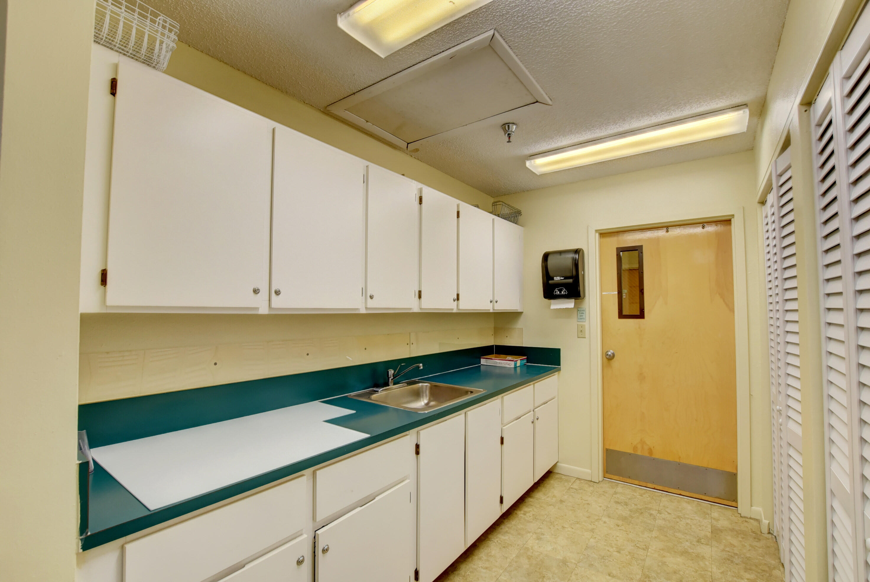 8089 Springtree Road Boca Raton, FL 33496 - Photo 35 of 44 a kitchen with granite countertop white cabinets and white appliances