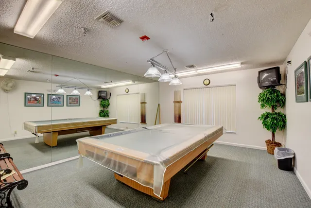 a view of a swimming pool with a chair and tables