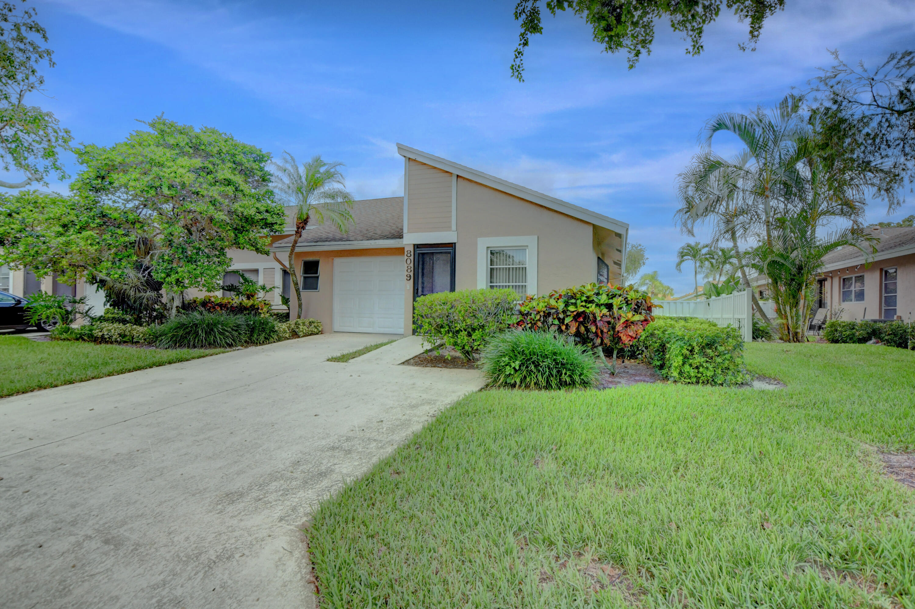 8089 Springtree Road Boca Raton, FL 33496 - Photo 8 of 44 a house view with a garden space