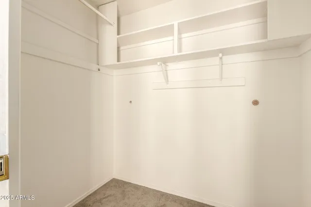 a view of an empty room with glass door and a window