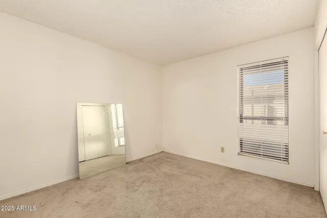 a view of a chair and table in backyard