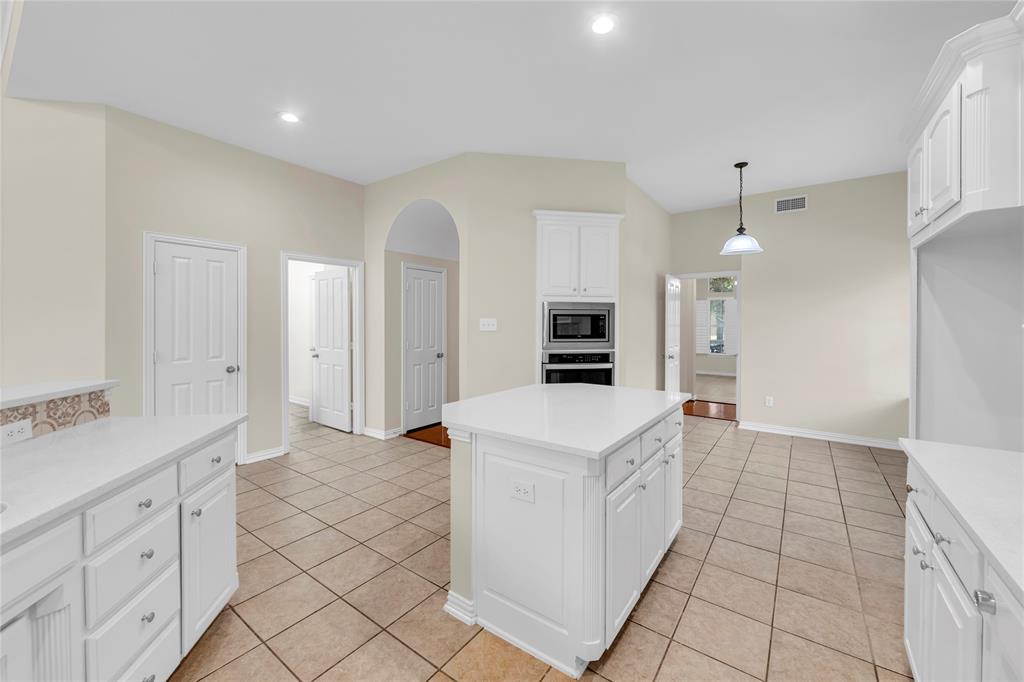 3920 Autumn Lane Bedford, TX 76021 - Photo 13 of 36 Kitchen featuring white cabinetry, light-toned tile flooring, and light wall paint