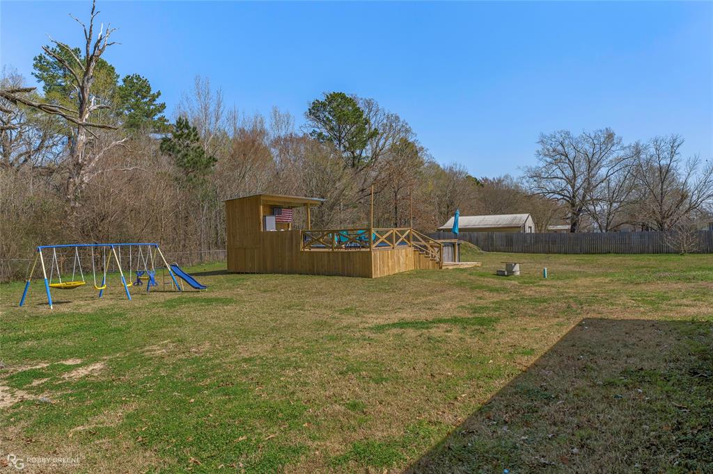 396 Collinswood Road Stonewall, LA 71078 - Photo 5 of 32 a backyard of a house with table and chairs