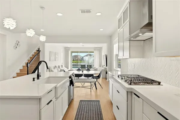 a large white kitchen with a large window