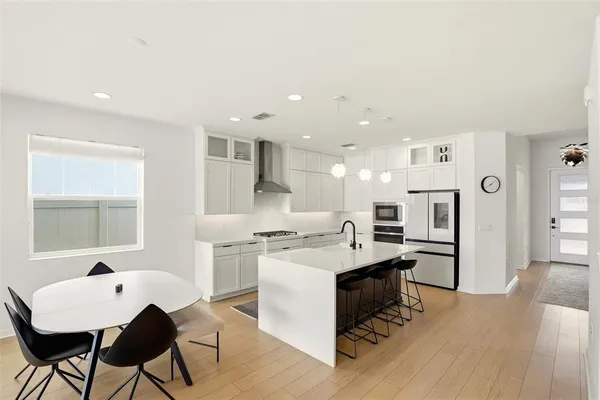 a living room with furniture flat screen tv and couches
